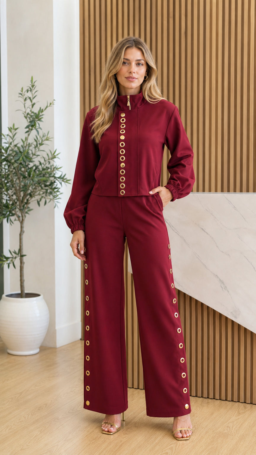 Front view of model wearing burgundy stand collar top and wide-leg pants set with gold hardware
