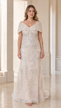 Front view of model wearing champagne sequin off-the-shoulder evening gown