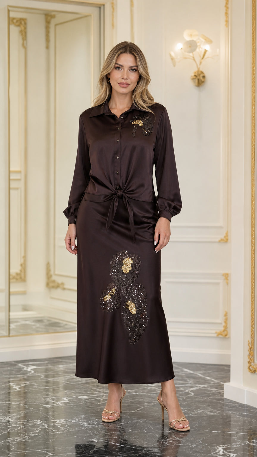 Model wearing dark brown satin tie-front blouse and matching sequined maxi skirt, front view