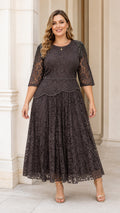 Front view of plus size model wearing dark charcoal beaded lace midi dress