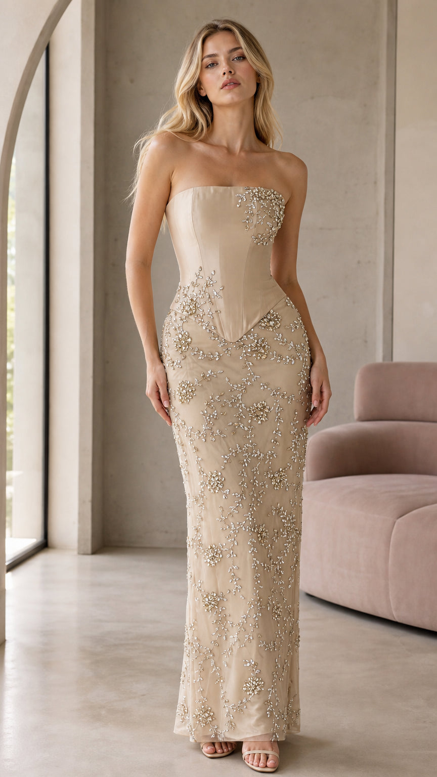 Front view of model wearing champagne strapless beaded corset maxi dress