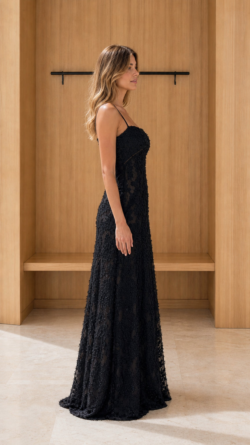 Side view of model wearing black lace maxi dress