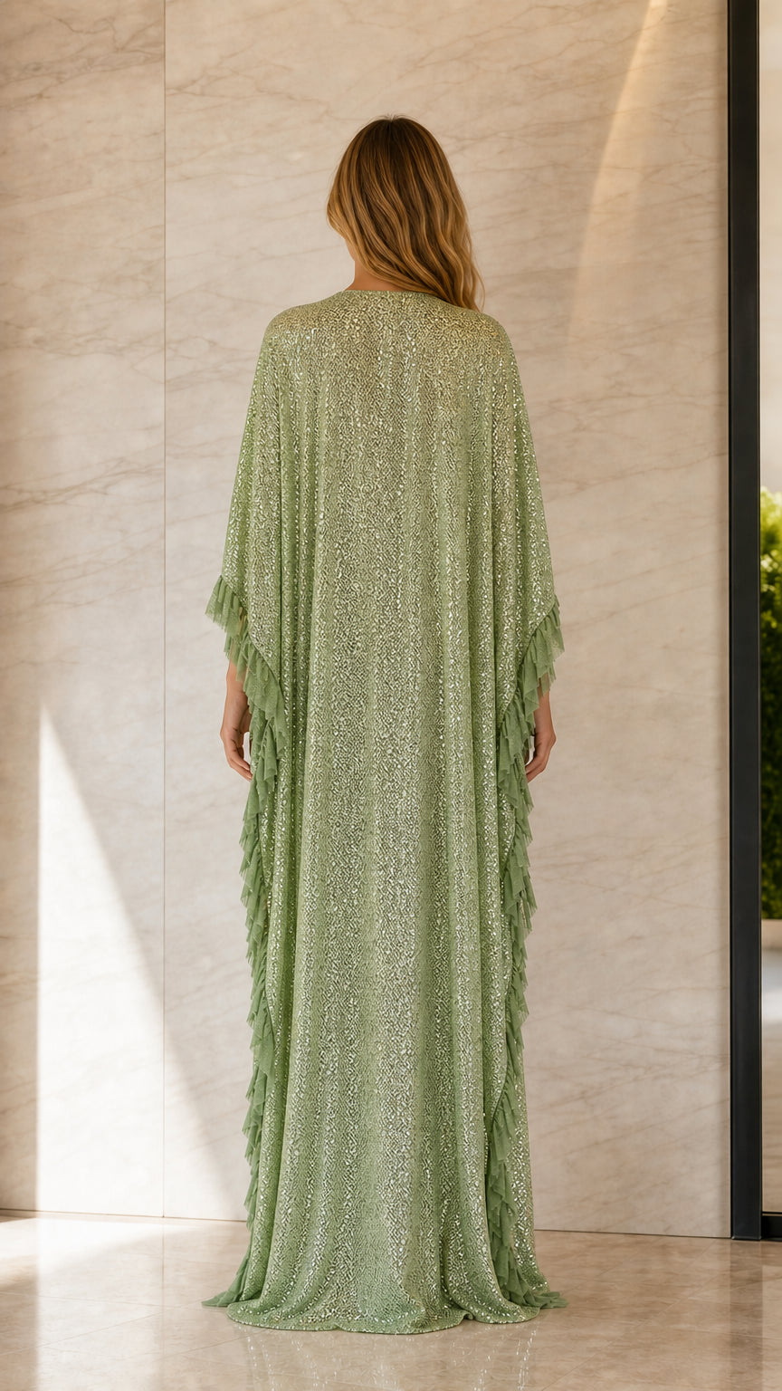 Back view of woman in sage green sequin maxi caftan