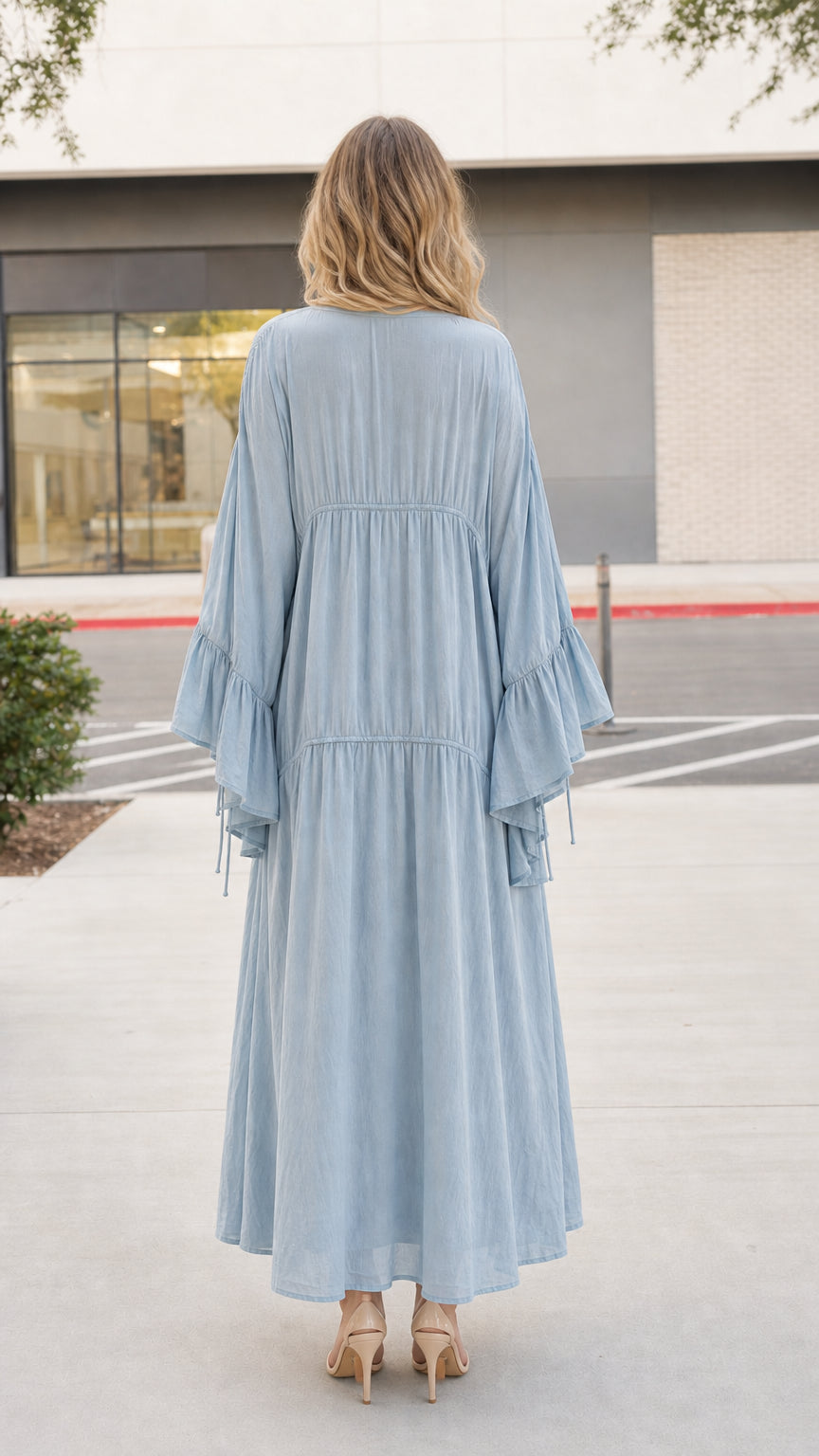 Model wearing light blue boho dress and kimono set, back view