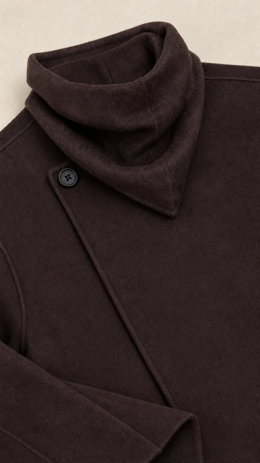 Close-up detail of the cowl collar and single button closure on dark brown jacket
