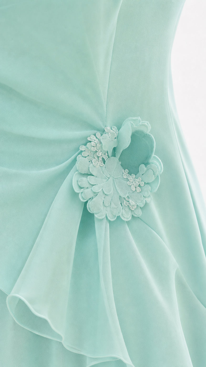 Close-up detail of tonal floral applique on mint chiffon dress