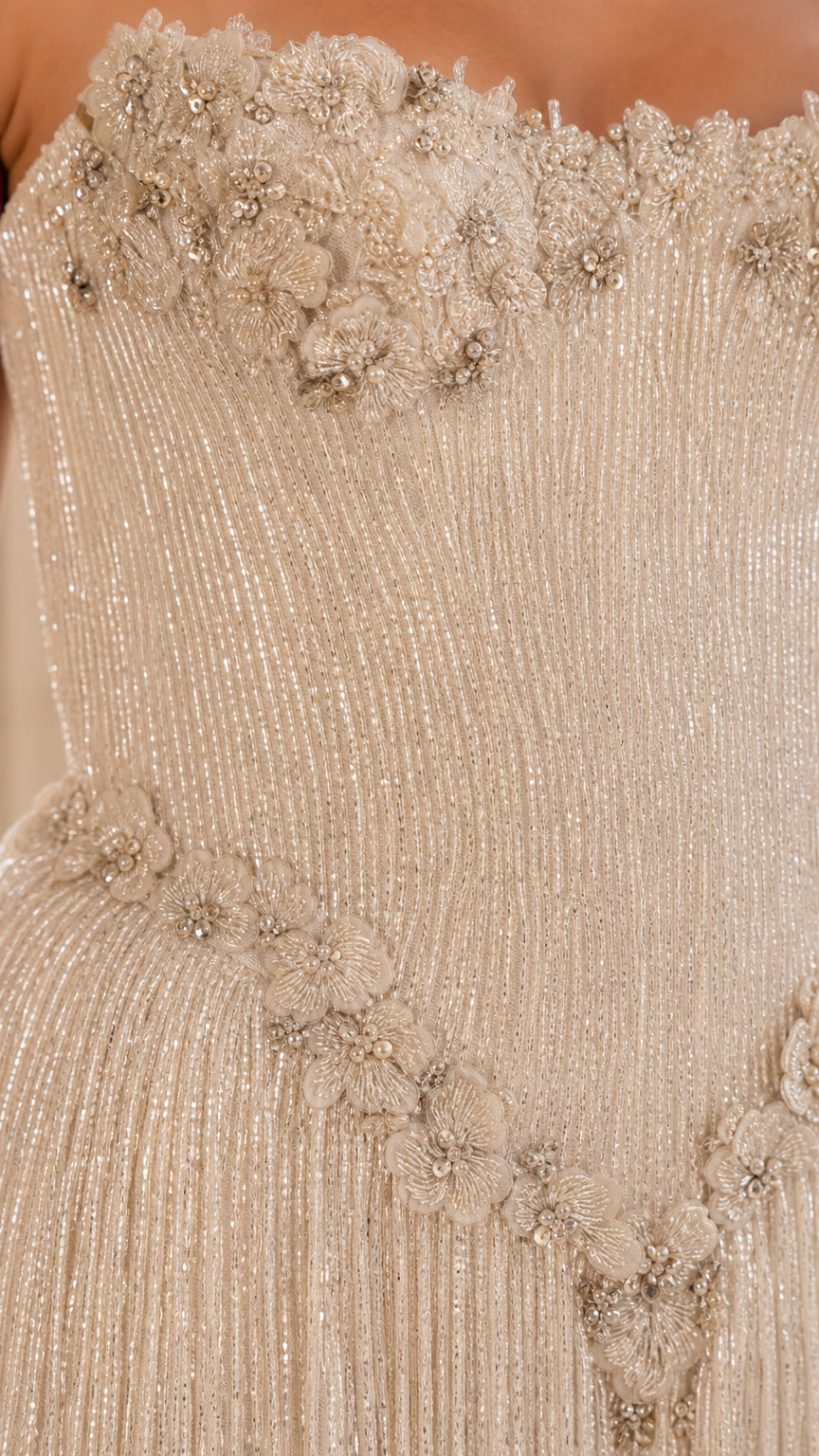 Close-up detail of beaded bodice and floral appliques