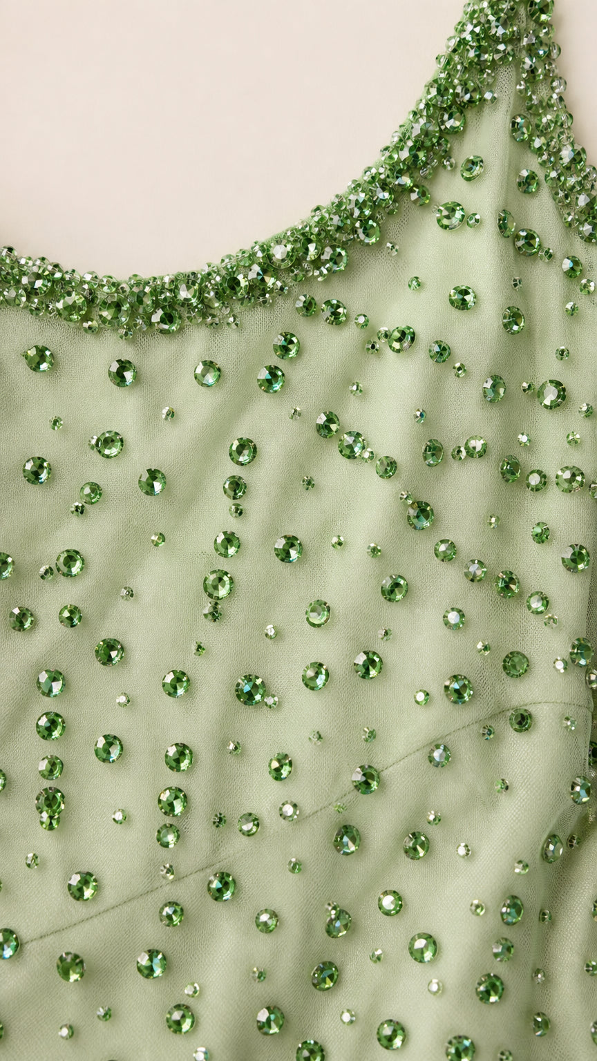 Close-up detail of neckline and crystal beading on sage green dress