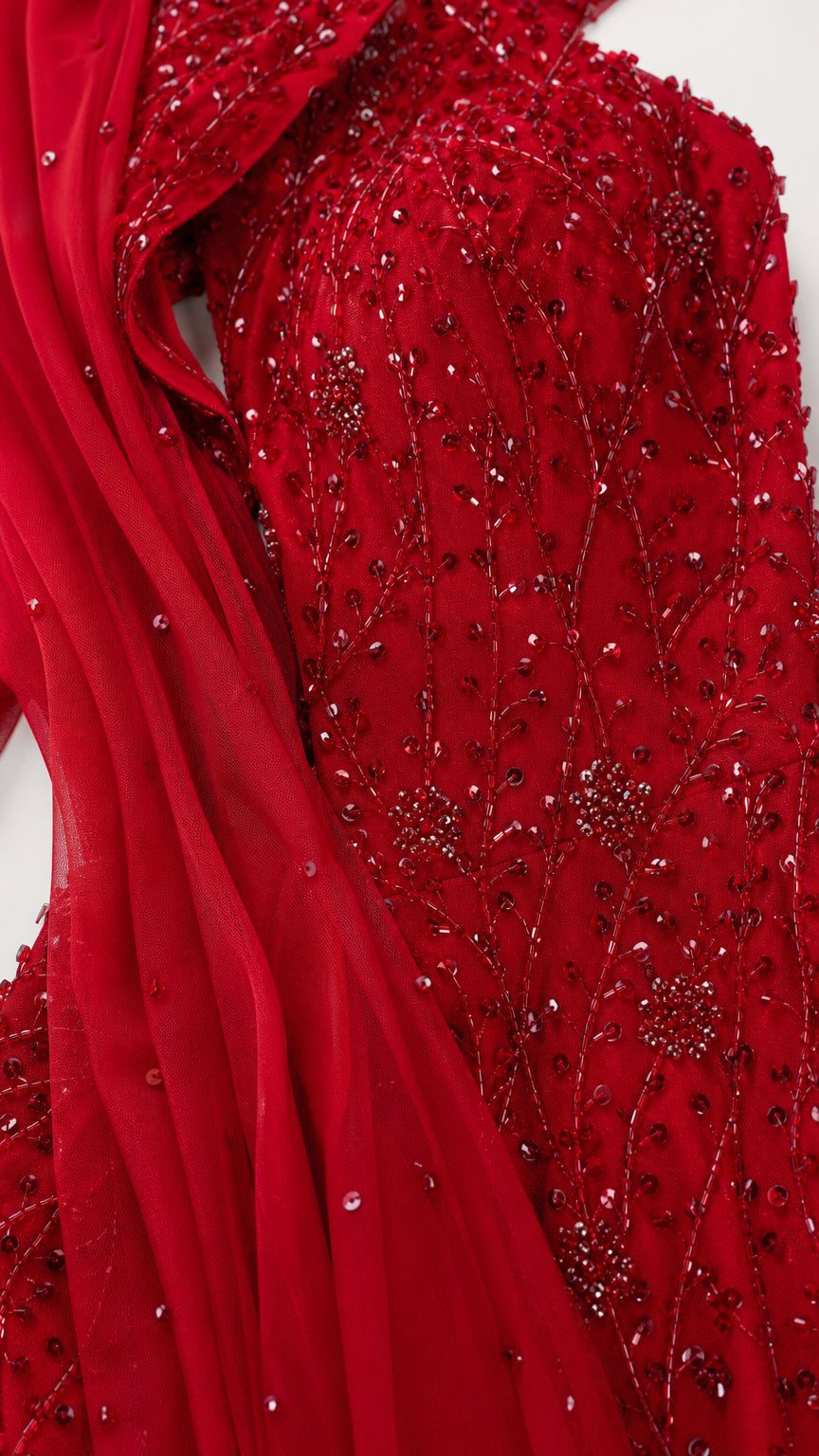 Close-up of red beaded texture and sheer cape fabric