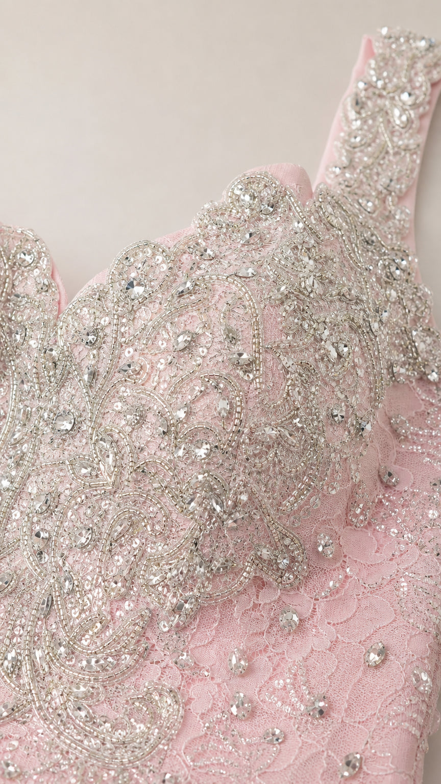 Close-up detail of silver beadwork and lace on bodice