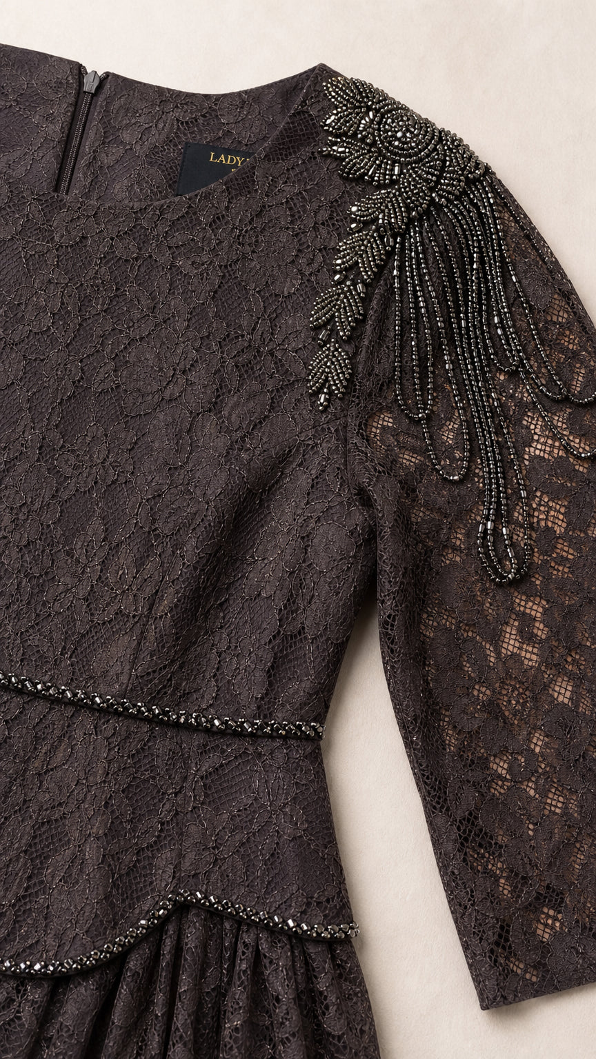 Close-up detail of beaded shoulder embellishments and lace texture