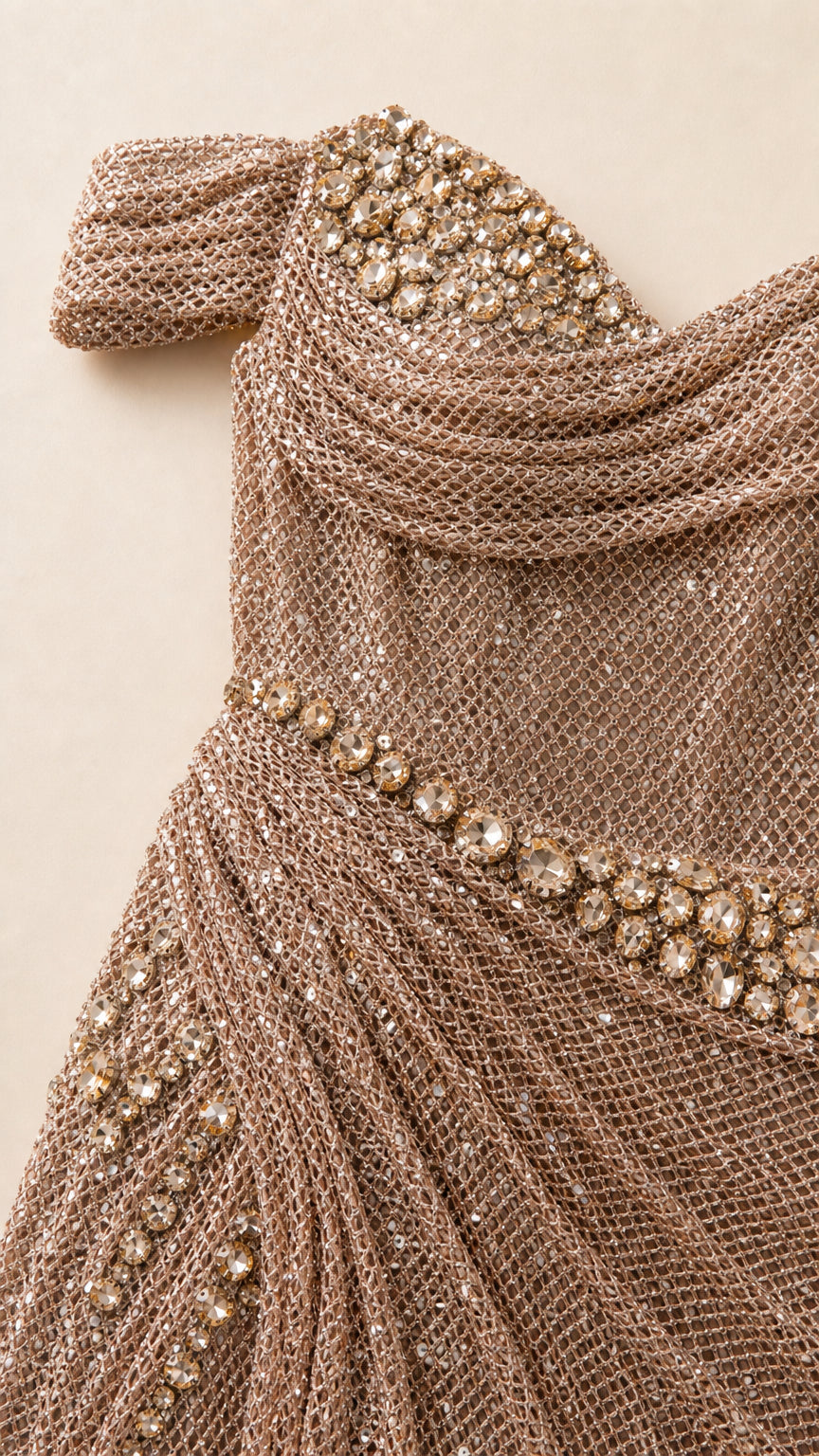 Close-up detail of crystal embellishments and metallic mesh texture on bodice
