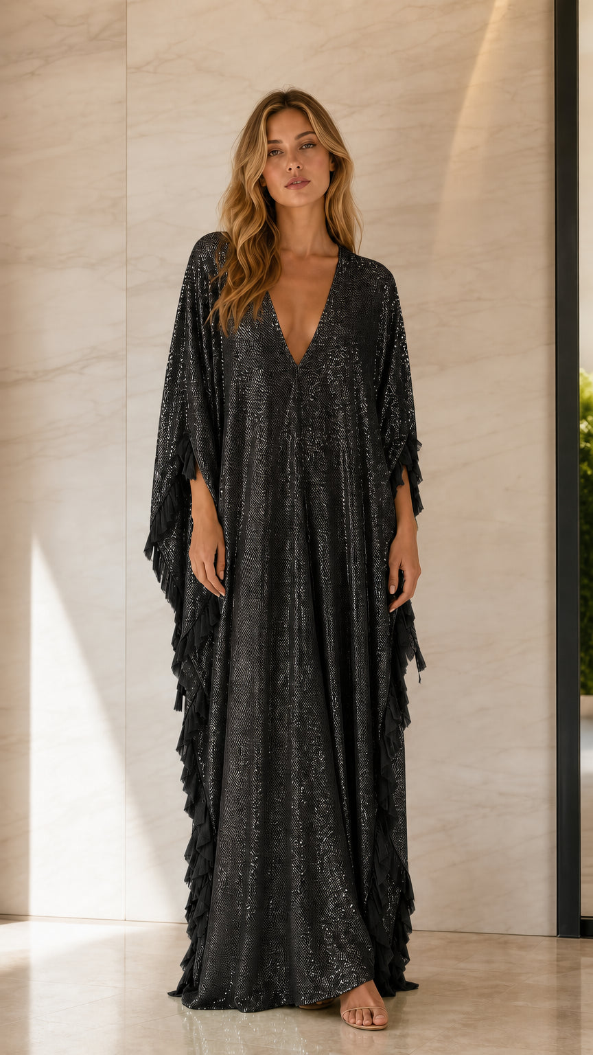 Front view of woman wearing black sequin caftan dress