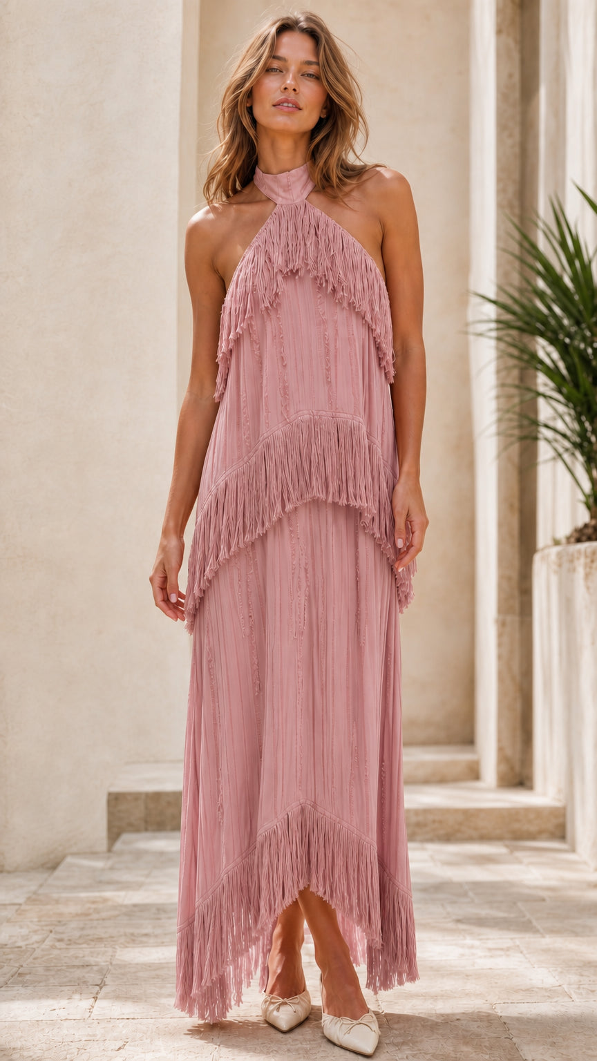Model wearing dusty rose halter neck tiered fringe maxi dress