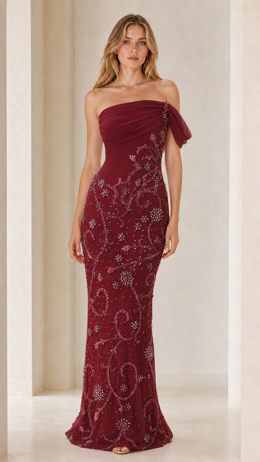 Front view of model wearing burgundy one-shoulder beaded evening gown