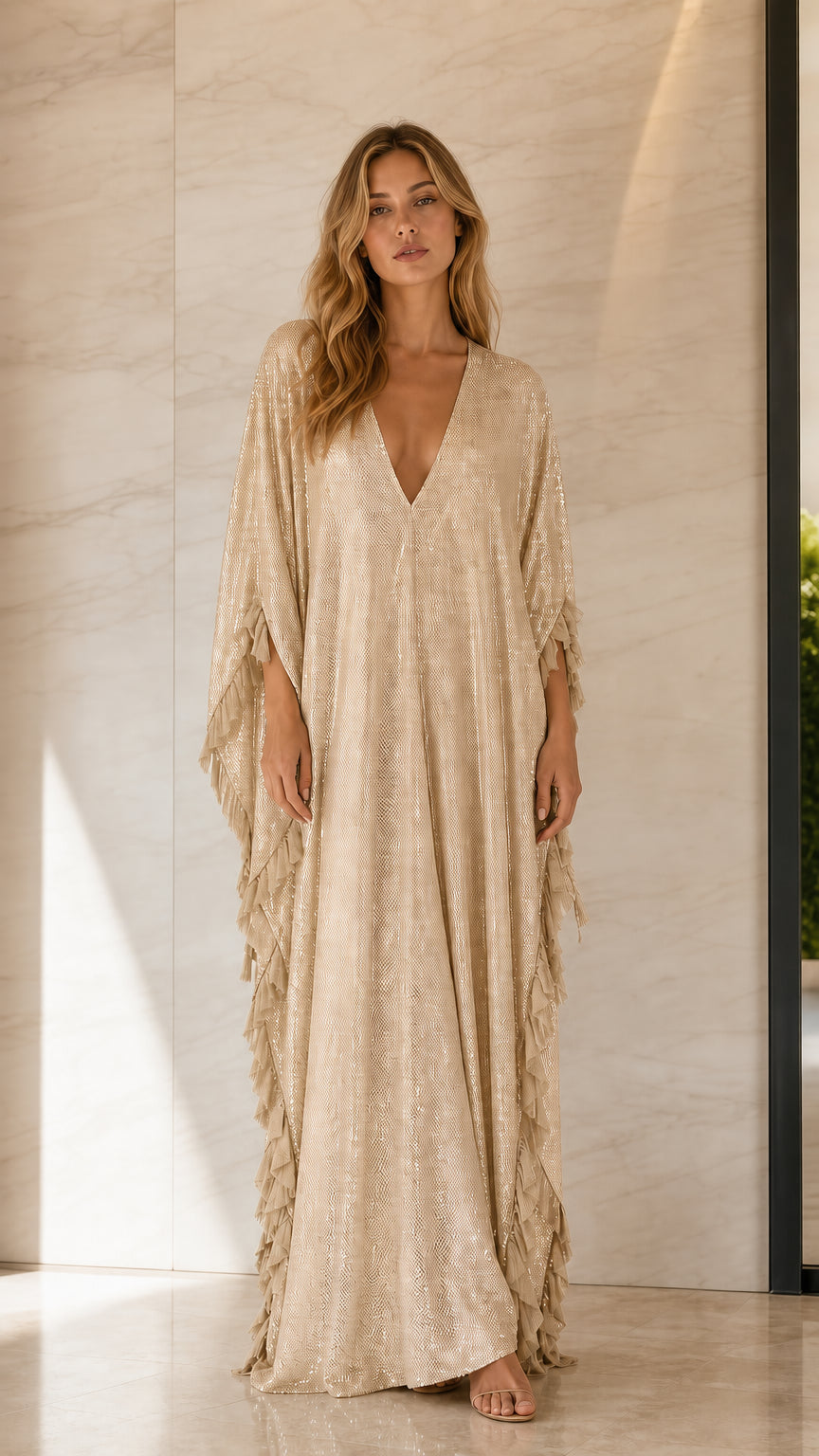 Front view of woman wearing champagne sequin caftan dress